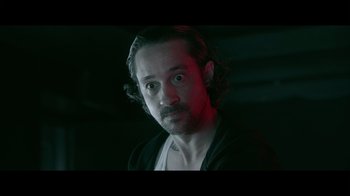 Movie still from “Adverse” (2020), directed by Brian A. Metcalf – A person with long hair; Close Up shot, Low angle