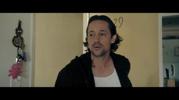 Movie still from “Adverse” (2020), directed by Brian A. Metcalf – A person with long black hair; Close Up shot, Over the shoulder angle