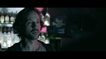 Movie still from “Adverse” (2020), directed by Brian A. Metcalf – A person in a room at night; Close Up shot, Over the shoulder angle