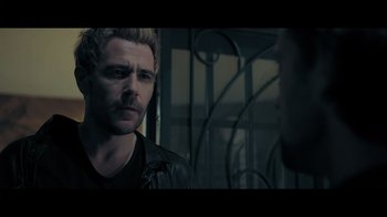 Movie still from “Adverse” (2020), directed by Brian A. Metcalf – A man in a leather jacket talking to another man in a leather jacket; Close Up shot, Over the shoulder angle