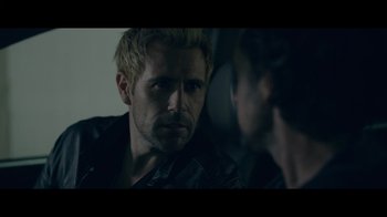 Movie still from “Adverse” (2020), directed by Brian A. Metcalf – A man in a leather jacket looking at another man in a leather jacket; Close Up shot, Over the shoulder angle
