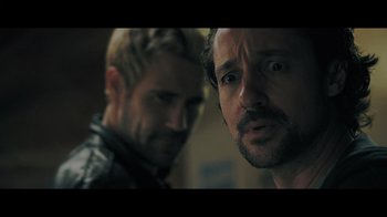 Movie still from “Adverse” (2020), directed by Brian A. Metcalf – Two men standing next to each other in front of a wall; Close Up shot, Over the shoulder angle