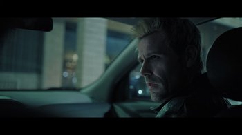 Movie still from “Adverse” (2020), directed by Brian A. Metcalf – A person in a car at night; Close Up shot, Over the shoulder angle