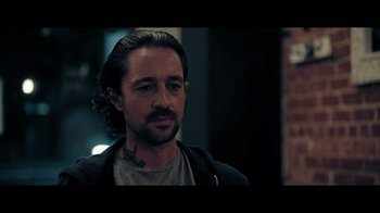 Movie still from “Adverse” (2020), directed by Brian A. Metcalf – A person with a beard; Close Up shot, Over the shoulder angle