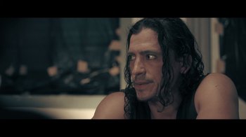 Movie still from “Adverse” (2020), directed by Brian A. Metcalf – A person with long black hair; Close Up shot, Over the shoulder angle