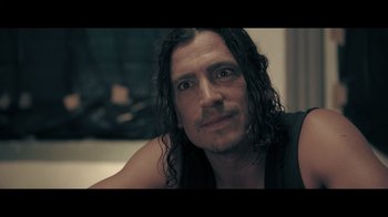 Movie still from “Adverse” (2020), directed by Brian A. Metcalf – A person with long black hair; Close Up shot, Over the shoulder angle