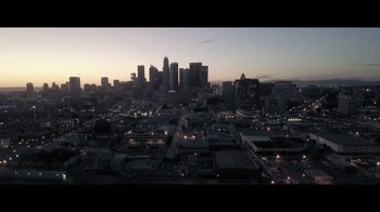 Movie still from “Adverse” (2020), directed by Brian A. Metcalf – An aerial view of a city at night with the lights on; Extreme Wide shot, High angle