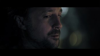 Movie still from “Adverse” (2020), directed by Brian A. Metcalf – A man with a beard looking to his left; Close Up shot, Over the shoulder angle