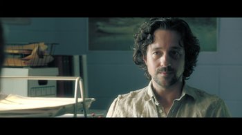 Movie still from “Adverse” (2020), directed by Brian A. Metcalf – A person wearing a shirt; Close Up shot, Over the shoulder angle