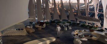 Movie still from “After Earth” (2013), directed by M. Night Shyamalan – A man standing in front of a bunch of sailboats in a room; Extreme Wide shot, High angle