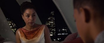 Movie still from “After Earth” (2013), directed by M. Night Shyamalan – A woman sitting in front of a building at night; Close Up shot, Over the shoulder angle