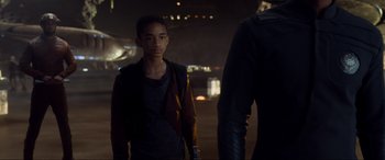 Movie still from “After Earth” (2013), directed by M. Night Shyamalan – A young boy standing next to a man in a city at night; Medium shot, Over the shoulder angle