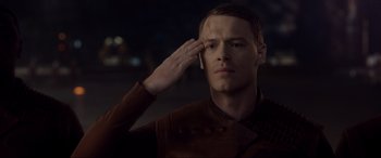 Movie still from “After Earth” (2013), directed by M. Night Shyamalan – A man saluting with one hand on his forehead; Medium shot, Low angle