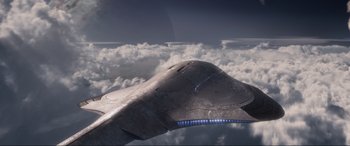 Movie still from “After Earth” (2013), directed by M. Night Shyamalan – An image of an airplane flying in the sky above the clouds; Extreme Wide shot, Low angle