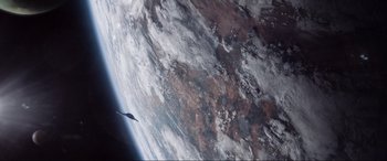 Movie still from “After Earth” (2013), directed by M. Night Shyamalan – An image of an airplane flying in the sky above the earth; Extreme Wide shot, Overhead angle