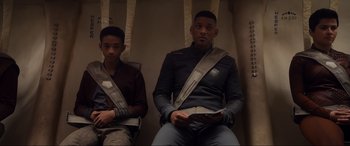 Movie still from “After Earth” (2013), directed by M. Night Shyamalan – Two young men sitting on a bench in a room; Medium shot, Low angle