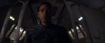 Movie still from “After Earth” (2013), directed by M. Night Shyamalan – A man in a uniform is looking at the camera; Close Up shot, Low angle