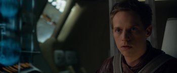 Movie still from “After Earth” (2013), directed by M. Night Shyamalan – A young man looking at the camera in a dark room; Close Up shot, Over the shoulder angle