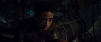 Movie still from “After Earth” (2013), directed by M. Night Shyamalan – A young man is looking down at his cell phone; Close Up shot, Over the shoulder angle