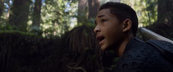 Movie still from “After Earth” (2013), directed by M. Night Shyamalan – A young man looking up at the sky in the woods; Close Up shot, Low angle