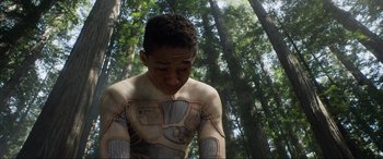 Movie still from “After Earth” (2013), directed by M. Night Shyamalan – A young man in a body suit standing in the woods; Close Up shot, Low angle
