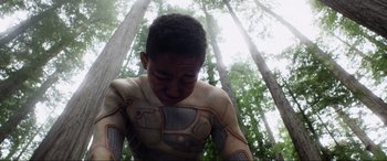 Movie still from “After Earth” (2013), directed by M. Night Shyamalan – A young man in a body suit in the woods; Close Up shot, Low angle