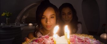 Movie still from “After Earth” (2013), directed by M. Night Shyamalan – A woman standing in front of a birthday cake with lit candles on it; Close Up shot, Over the shoulder angle