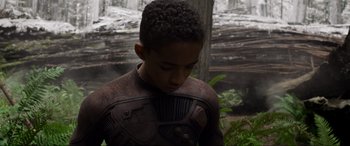 Movie still from “After Earth” (2013), directed by M. Night Shyamalan – A young boy wearing a body suit in the woods; Medium shot, High angle