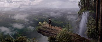 Movie still from “After Earth” (2013), directed by M. Night Shyamalan – A man standing on top of a cliff looking out over a lake; Extreme Wide shot, High angle