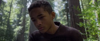 Movie still from “After Earth” (2013), directed by M. Night Shyamalan – A person with a tree in the background; Close Up shot, Low angle