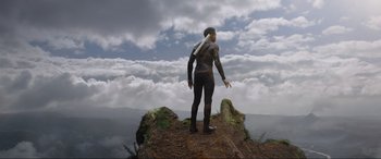 Movie still from “After Earth” (2013), directed by M. Night Shyamalan – A man standing on top of a hill with clouds in the background; Extreme Wide shot, Low angle