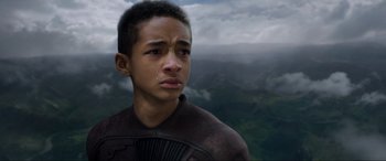 Movie still from “After Earth” (2013), directed by M. Night Shyamalan – A young boy is crying while standing in front of a mountain; Close Up shot, High angle