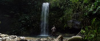 Movie still from “After Earth” (2013), directed by M. Night Shyamalan – A man standing in front of a large waterfall; Extreme Wide shot, Low angle