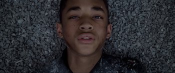 Movie still from “After Earth” (2013), directed by M. Night Shyamalan – A young boy laying on top of a pile of rocks; Close Up shot, Overhead angle