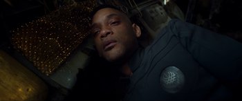 Movie still from “After Earth” (2013), directed by M. Night Shyamalan – A person laying on the ground; Close Up shot, Overhead angle