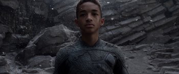 Movie still from “After Earth” (2013), directed by M. Night Shyamalan – A young man wearing a body armor stands in front of a stone wall; Close Up shot, Low angle