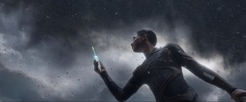 Movie still from “After Earth” (2013), directed by M. Night Shyamalan – A man holding an electronic device in his hand; Medium shot, Low angle