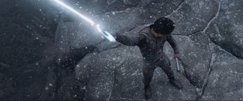 Movie still from “After Earth” (2013), directed by M. Night Shyamalan – A man holding a light saber in the snow; Medium shot, High angle