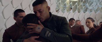 Movie still from “After Earth” (2013), directed by M. Night Shyamalan – A man in military fatigues hugging another man; Close Up shot, Over the shoulder angle
