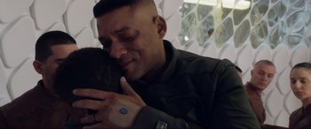 Movie still from “After Earth” (2013), directed by M. Night Shyamalan – A man is hugging another man with his eyes closed; Close Up shot, Over the shoulder angle