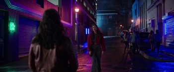 Movie still from “Afterlife of the Party” (2021), directed by Stephen Herek – A woman walking down a street at night; Wide shot, Over the shoulder angle