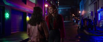 Movie still from “Afterlife of the Party” (2021), directed by Stephen Herek – Two women are talking on the sidewalk at night; Medium shot, Over the shoulder angle