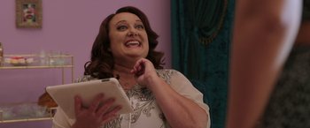 Movie still from “Afterlife of the Party” (2021), directed by Stephen Herek – A woman holding an ipad in her hands; Close Up shot, Over the shoulder angle