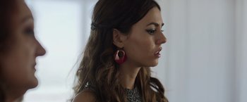Movie still from “Afterlife of the Party” (2021), directed by Stephen Herek – A person wearing a pair of earrings; Close Up shot, Low angle