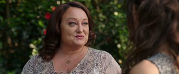 Movie still from “Afterlife of the Party” (2021), directed by Stephen Herek – A person wearing a necklace; Close Up shot, Over the shoulder angle