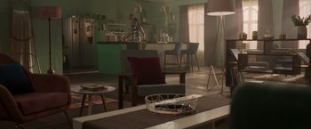 Movie still from “Afterlife of the Party” (2021), directed by Stephen Herek – A living room with chairs , a table , and a counter; Wide shot, High angle