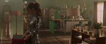 Movie still from “Afterlife of the Party” (2021), directed by Stephen Herek – A woman standing in front of an open kitchen; Medium shot, Over the shoulder angle