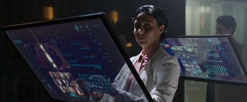 Movie still from “Afterlife of the Party” (2021), directed by Stephen Herek – A woman in a white lab coat holding a keyboard; Close Up shot, Over the shoulder angle