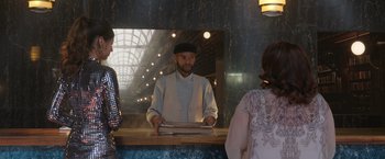 Movie still from “Afterlife of the Party” (2021), directed by Stephen Herek – A man standing in front of a mirror holding papers; Medium shot, Over the shoulder angle