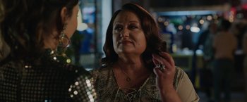 Movie still from “Afterlife of the Party” (2021), directed by Stephen Herek – A woman is talking to a man in front of a building; Close Up shot, Over the shoulder angle